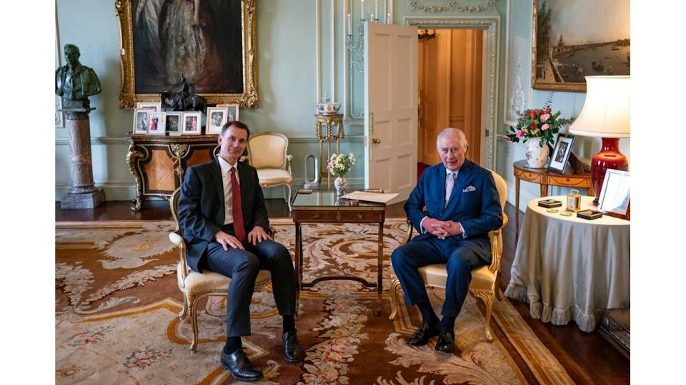 King Charles III and Britain's Chancellor of the Exchequer Jeremy Hunt, pose for a photograph during their meeting in the private audience room at Buckingham Palace