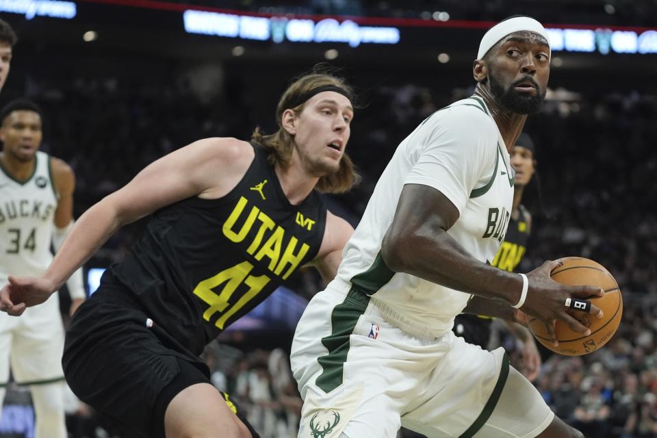 Milwaukee Bucks' Bobby Portis tries to get past Utah Jazz's Kelly Olynyk during the first half of an NBA basketball game Monday, Jan. 8, 2024, in Milwaukee. (AP Photo/Morry Gash)