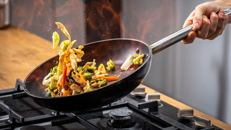 a wok cooking vegetables