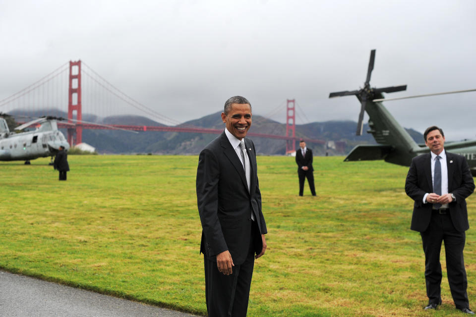 US President Barack Obama smiles before boarding Marine One helicopter from a field overlooking the iconic golden gate bridge in San Francisco, California, on April 4, 2013. Obama is in California to attend two DCCC fund rising events. AFP PHOTO/Jewel Samad        