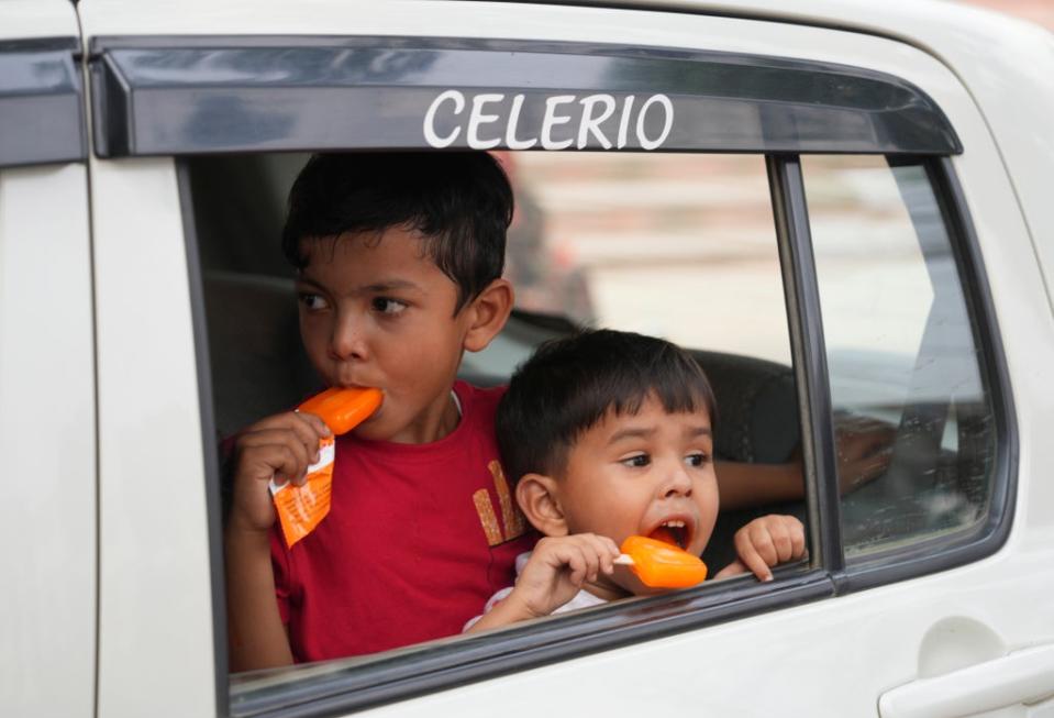 Children eat ice cream in Prayagraj, in the northern Indian state of Uttar Pradesh. (AP)