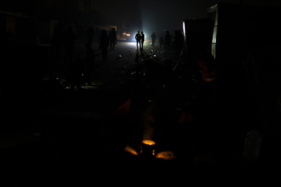 Palestinians displaced by the Israeli bombardment of the Gaza Strip stand at the makeshift tent camp in the Muwasi area on Sunday, Dec. 31, 2023. Israel has encouraged Palestinians to move to Muwasi, telling them they will be safe from bombing. (AP Photo/Fatima Shbair)