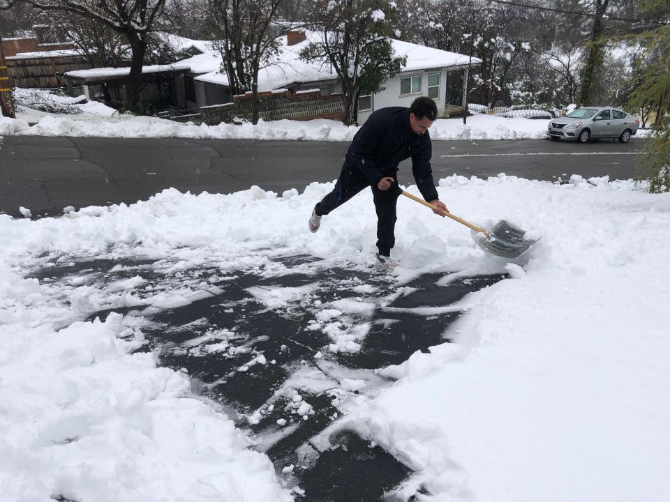 Redding resident James Williams faces an uphill climb, shoveling snow through his driveway before heading to work on Friday, Feb. 24, 2022.