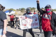 In this image provided by the Navajo Nation Office of the Speaker, family members and advocates participating in a walk on the Navajo Nation, Wednesday, May 5, 2021, near Window Rock, Ariz., to commemorate a day of awareness for the crisis of violence against Indigenous women and children. (Byron C. Shorty, Navajo Nation Office of the Speaker via AP)