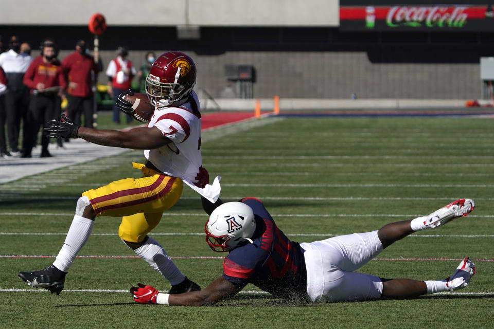 Arizona linebacker Jalen Harris (49) tackles Southern California running back Stephen Carr (7) in the first half during an NCAA college football game, Saturday, Nov. 14, 2020, in Tucson, Ariz. (AP Photo/Rick Scuteri)