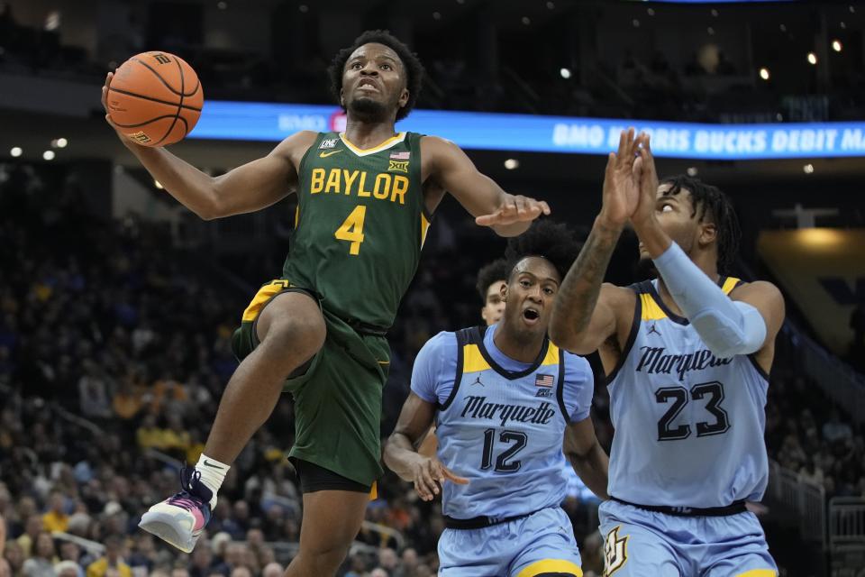 Baylor's LJ Cryer shoots past Marquette's David Joplin during the second half of an NCAA college basketball game Tuesday, Nov. 29, 2022, in Milwaukee. (AP Photo/Morry Gash)