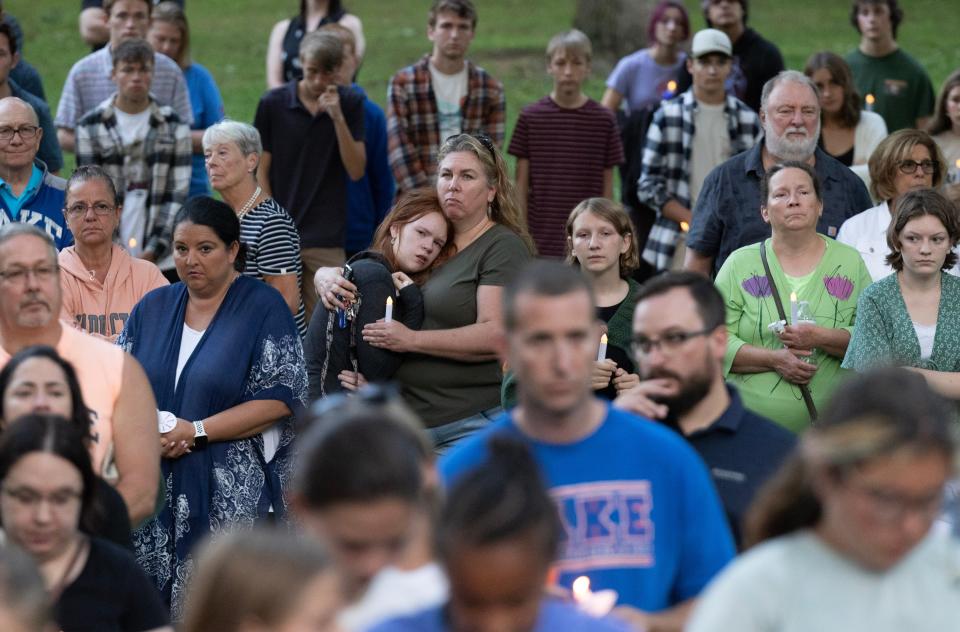Hundreds gathered during a candlelight vigil Saturday for the Dunham family at Hartville Memorial Park. All five members of the family died this week in what investigators described as a homicide-suicide.