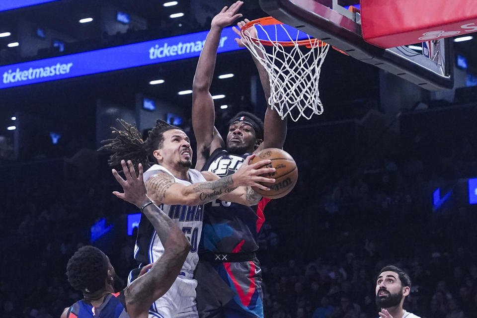 Orlando Magic's Cole Anthony, top left, goes for a layup during the second period of an NBA basketball game the against Brooklyn Nets, Saturday, Dec. 2, 2023, in New York. (AP Photo/Bebeto Matthews)