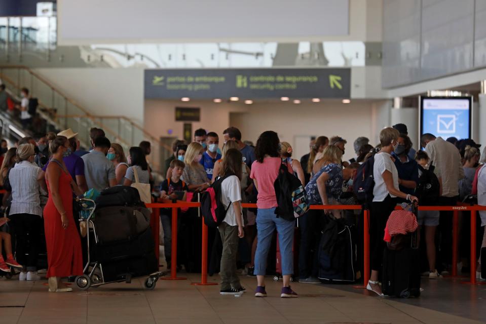 <p>People wait in queues at Faro airport </p> (REUTERS)