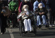 Elderly people are wheeled away after getting their shot of the COVID-19 Pfizer vaccine in Mexico City, on Monday, March 8, 2021. (AP Photo / Marco Ugarte)