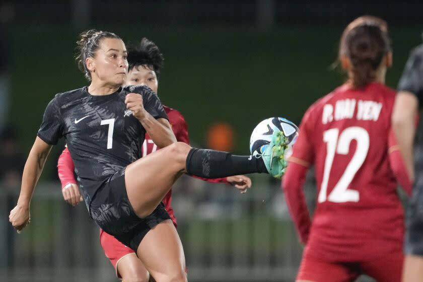 New Zealand's Ali Riley, left, kicks the ball as Vietnam's Hai Yen Pham, right, watches during the New Zealand.