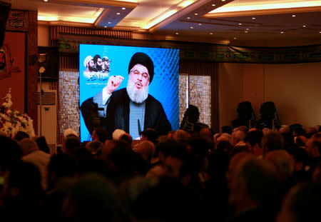 Lebanon's Hezbollah leader Sayyed Hassan Nasrallah addresses his supporters through a screen during a rally commemorating the annual Hezbollah Martyrs' Leaders Day in Jebshit village, southern Lebanon February 16, 2017. REUTERS/Ali Hashisho