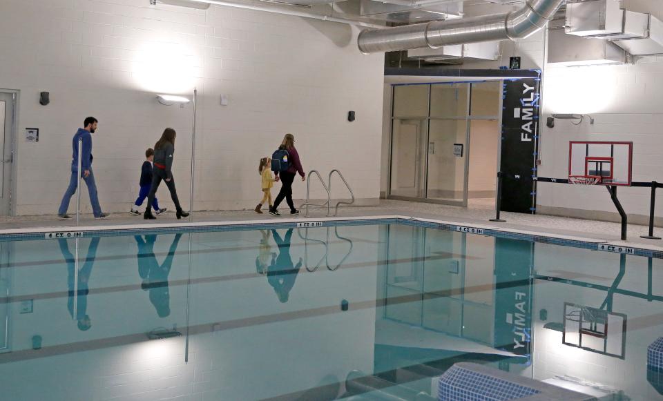 People tour the pool area of the Young Family Athletic Center during a grand opening Monday in Norman.