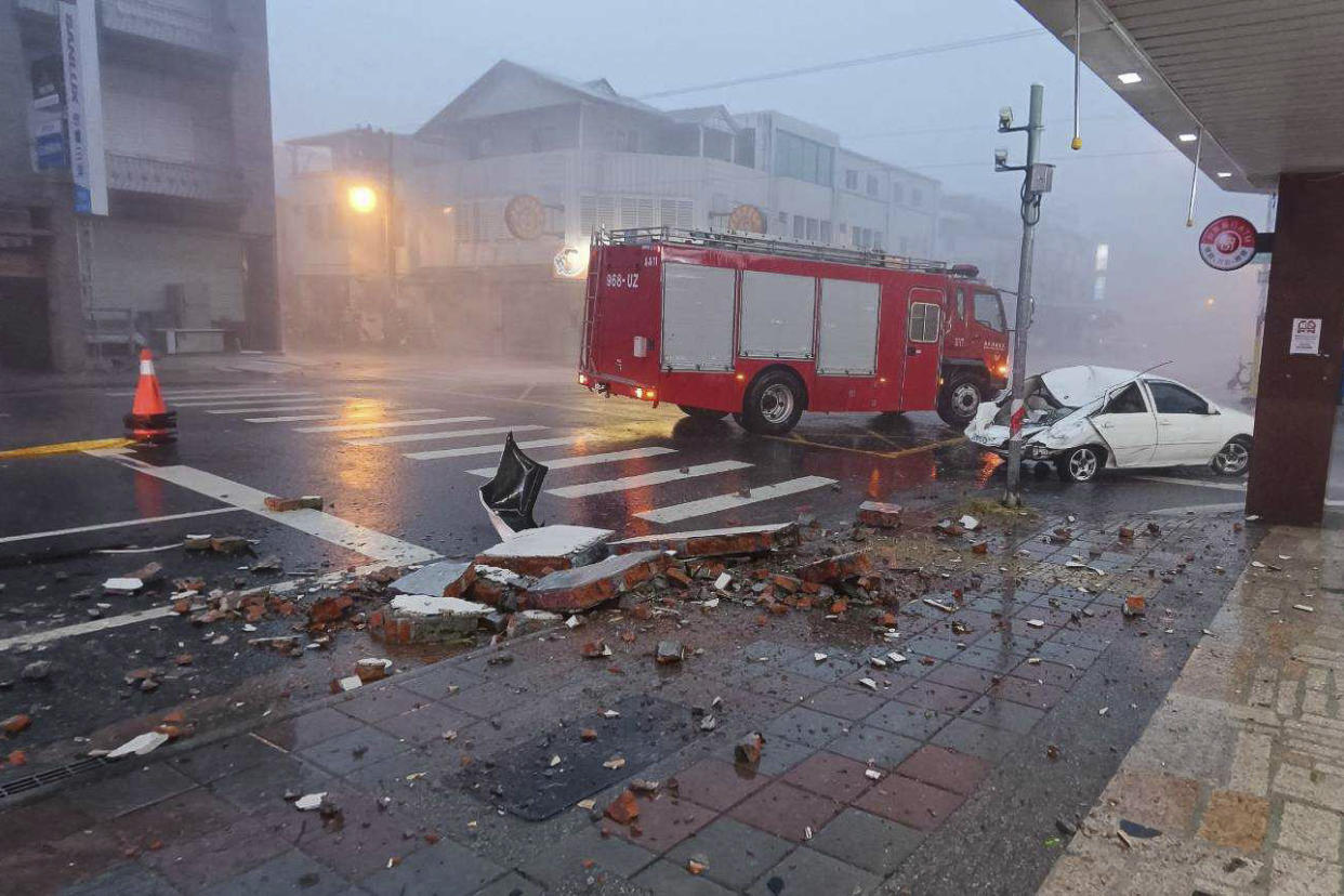 A car was hit by falling walls after Typhoon Gaemi made landfall in Taiwan on Wednesday. 