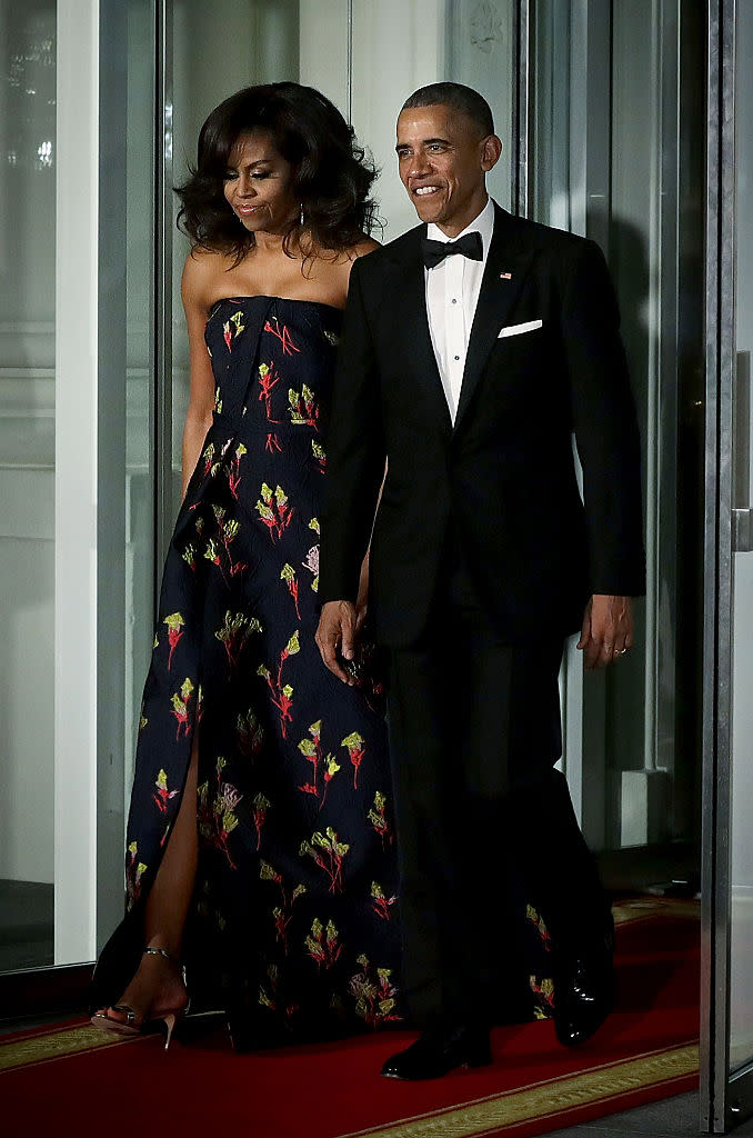 The First Lady wore a blue Wu gown with a playful floral print to the White House dinner for Canadian Prime Minister Justin Trudeau. (Photo: Getty)