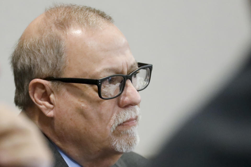 FILE - Defendant Gregory McMichael looks on during his trial along with and his son, Travis McMichael, and a neighbor, William "Roddie" Bryan, in the February 2020 slaying of 25-year-old Ahmaud Arbery, on Nov. 19, 2021, at the Glynn County Courthouse in Brunswick, Ga. Travis McMichael, the man convicted of murder for shooting Ahmaud Arbery is withdrawing his guilty plea on a federal hate crime charge. McMichael announced his decision Friday, Feb. 4, 2022. (Octavio Jones/Pool Photo via AP)