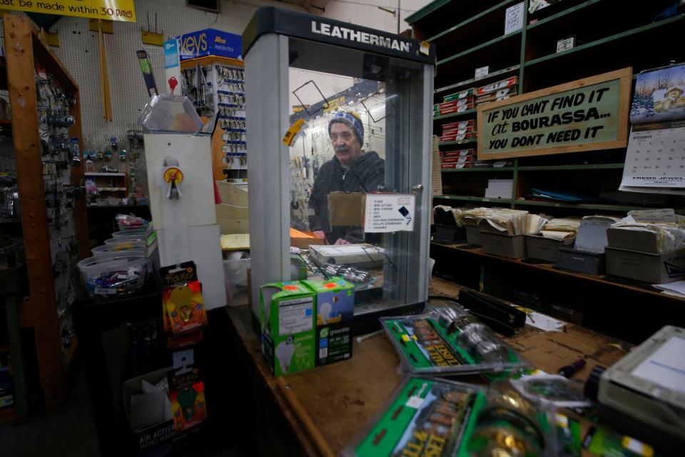 Gerard Bourassa is reflected on an empty utility tool case at Bourassa Hardware on Acushnet Avenue in New Bedford set to close in January after one hundred years of operation. Mr. Bourassa's grandfather started the store.