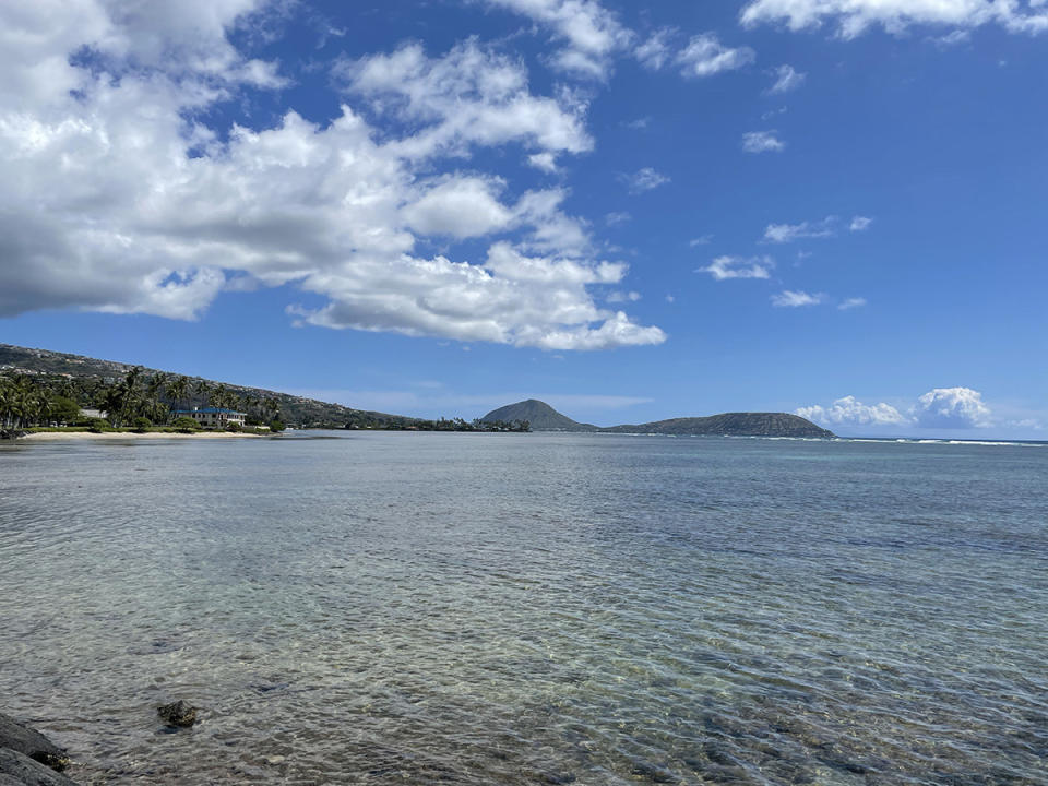 A view of the ocean and mountains in the distance along the Oahu shoreline