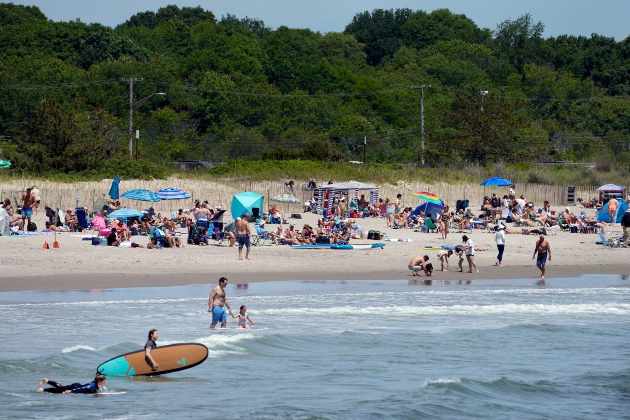 Surfers catch waves at Narragansett Town Beach in June.