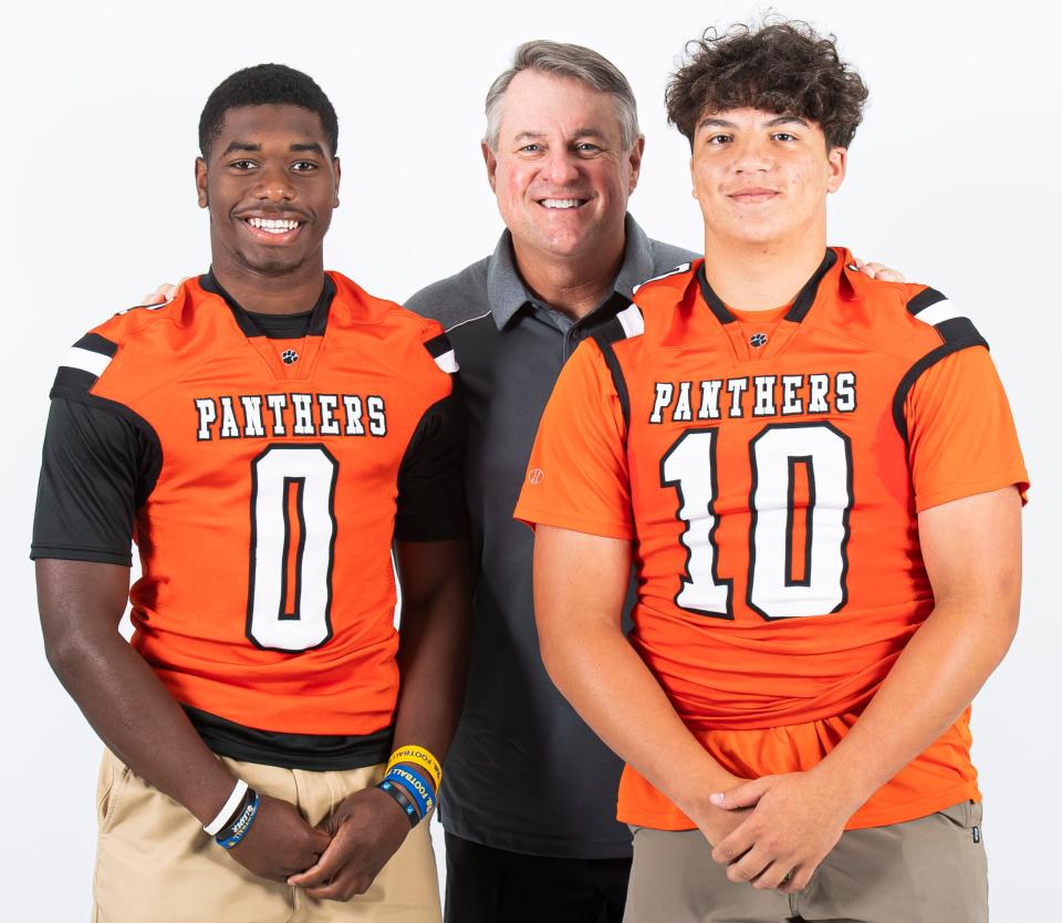 Central York football players Juelz Goff (0) and Domenic Grove (10) pose for a photo with head coach Gerry Yonchiuk during YAIAA football media day on Tuesday, August 1, 2023, in York.