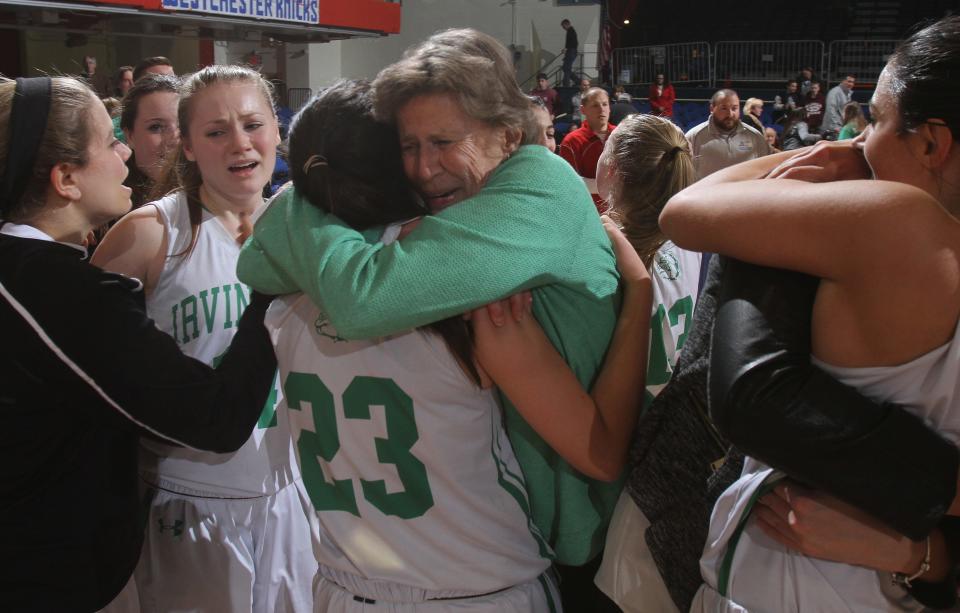 Irvington coach Gina Maher hugs Havanna Hall as Irvington players celebrate after defeating Ardsley 50-48 in the Section 1 Class B championship game at the Westchester County Center in White Plains Feb. 28, 2015. 