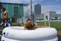 Argentina's Santiago Mare soaks in an ice bath following a men's rugby sevens practice at the Tokyo 2020 Olympics, in Tokyo, Friday, July 23, 2021. (AP Photo/David Goldman)
