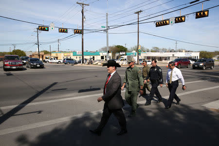 Christopher Combs (L), special agent in charge of the FBI's San Antonio division, departs a news conference in Pflugerville, Texas, U.S., March 21, 2018. REUTERS/Loren Elliott