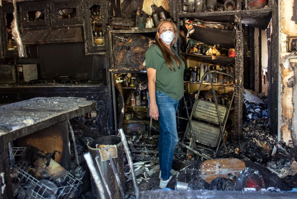 Loretta Reel surveys the damage to her in-laws' home in the Porter Ranch area of Los Angeles on Oct. 12, 2019.