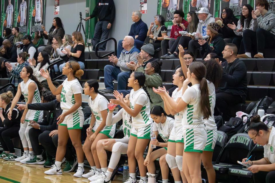 St. Mary's girls basketball team cheer and shout “SWOOSH” as their teammate scores during the MLK Showcase Tournament at St. Marys High School in Stockton, CA. on Jan. 13, 2024.