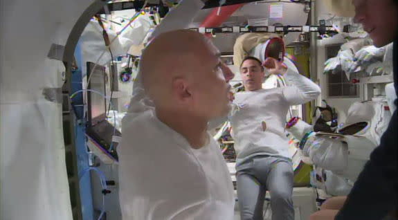 Astronauts Parmitano (foreground) and Cassidy (background) wrap-up the spacewalk of July 16, 2013, which ended prematurely owing to water leaking inside Parmitano's helmet.