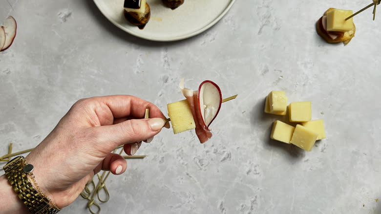 cheese, meat, apple on skewer