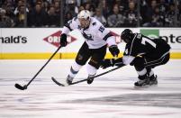 San Jose Sharks left wing James Sheppard, left, is tripped by Los Angeles Kings left wing Dwight King during the first period in Game 3 of an NHL hockey first-round playoff series , Tuesday, April 22, 2014, in Los Angeles. (AP Photo/Mark J. Terrill)