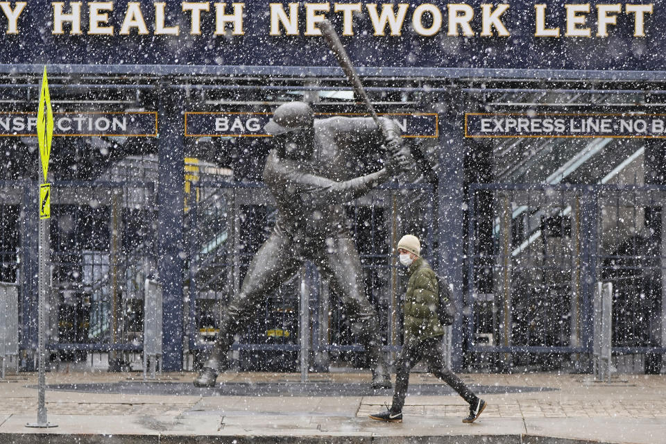 Snow falls on a statue of Pittsburgh Pirates baseball Hall of Famer Willie Stargell, outside PNC Park on Pittsburgh's Northside, Thursday, April 1, 2021. The Pirates open the season in Chicago today against the Chicago Cubs. The Pirates' home opener is April 8, against the Chicago Cubs. (AP Photo/Gene J. Puskar)