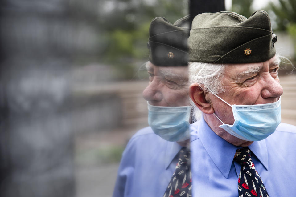 United States Marine Corps veteran John Kline wearing a protective face mask as a precaution against the coronavirus, pays his respects at the Korean War Memorial, in Philadelphia, on Memorial Day, Monday, May 25, 2020. (AP Photo/Matt Rourke)