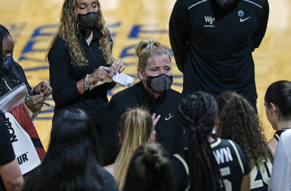 Wake Forest head coach Jennifer Hoover encourages her team during the first half of a college basketball game in the first round of the women's NCAA tournament at the Greehey Arena in San Antonio, Texas, Sunday, March 21, 2021. (AP Photo/Ronald Cortes)