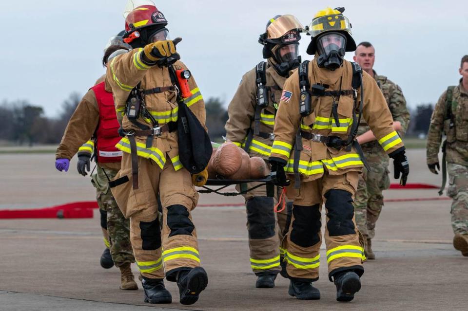U.S. Air Force firefighters from the 375th Air Mobility Wing carry a simulated patient off the flightline March 16 on Scott Air Force Base. The team was a part of a Major Accident Response Exercise hosted on the base.