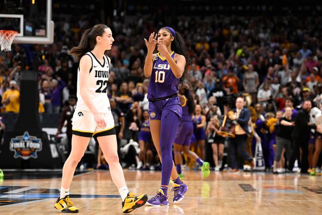 LSU Angel Reese (10) taunting Iowa Caitlin Clark (22) and pointing to her ring finger after winning the championship game vs Iowa at American Airlines Arena Dallas, Texas.