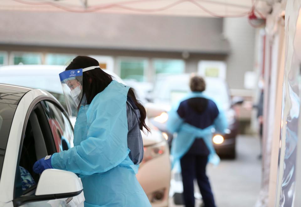 Medical staff with Salem Health work to test patients for COVID-19 at Salem Health Lab on Thursday, Jan. 6, 2022 in Salem, Ore.