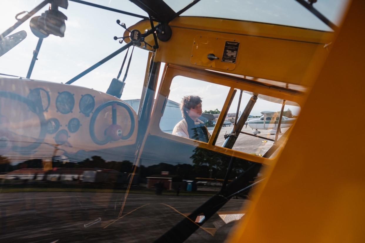 Wright Flight student Corbin Schilling learns about flight instructor Tim Newell's Taylorcraft airplane before getting the opportunity to take flight on Saturday at Harry Clever Field in New Philadelphia.