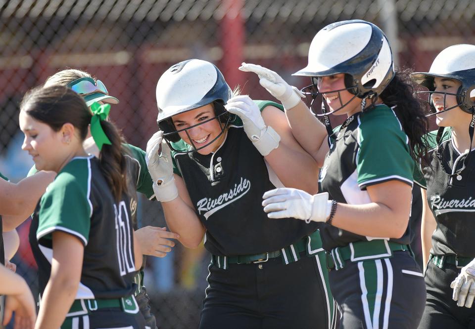 Riverside's Sam Rosenberger is greeted by her teammates after hitting a home run during Wednesday's game at Freedom Area High School.
Riverside won the game 8-4.