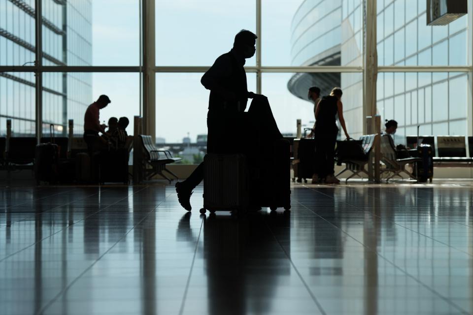 A passenger walks through the arrival lobby of Haneda Airport in Tokyo, Japan, on Tuesday, Oct. 11, 2022.  Photographer: Toru Hanai/Bloomberg