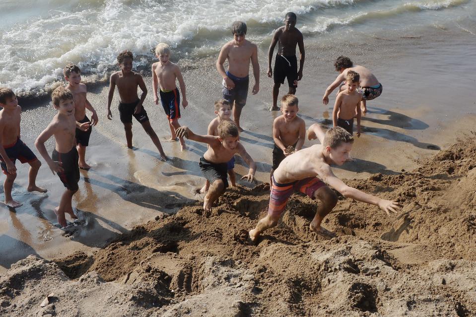 Rambler Wrestling Club members, including T.J. Markijohn, 9, near right, climb a slope on Beach 7.