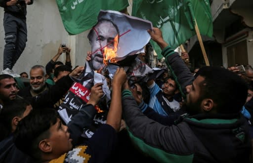Palestinian demonstrators burn pictures of Israeli Defence Minister Avigdor Lieberman who has resigned in protest at a Gaza ceasefire hailed as a victory by the territory's Islamist rulers Hamas