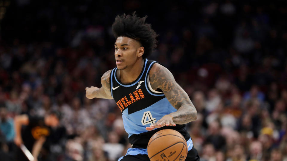 Kevin Porter Jr. immediately crumpled to the floor and clutched his knee after having his heel stepped on. (AP Photo/Tony Dejak)