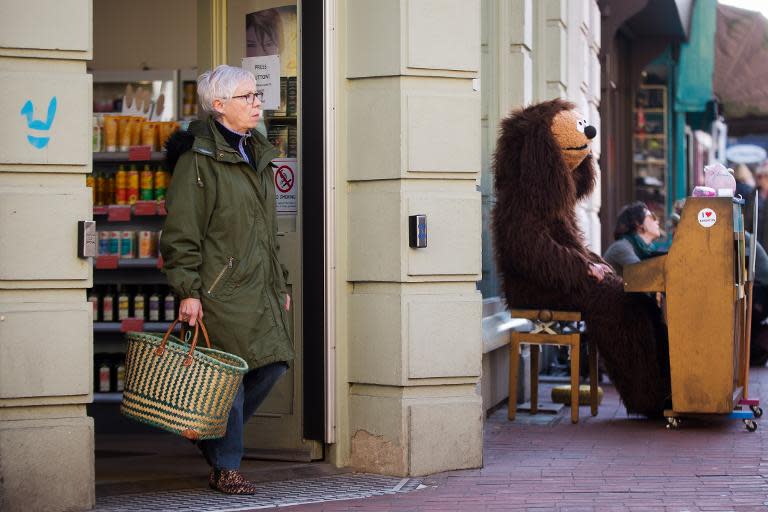 A busker is seen performing in Brighton, southern England, on March 29, 2014