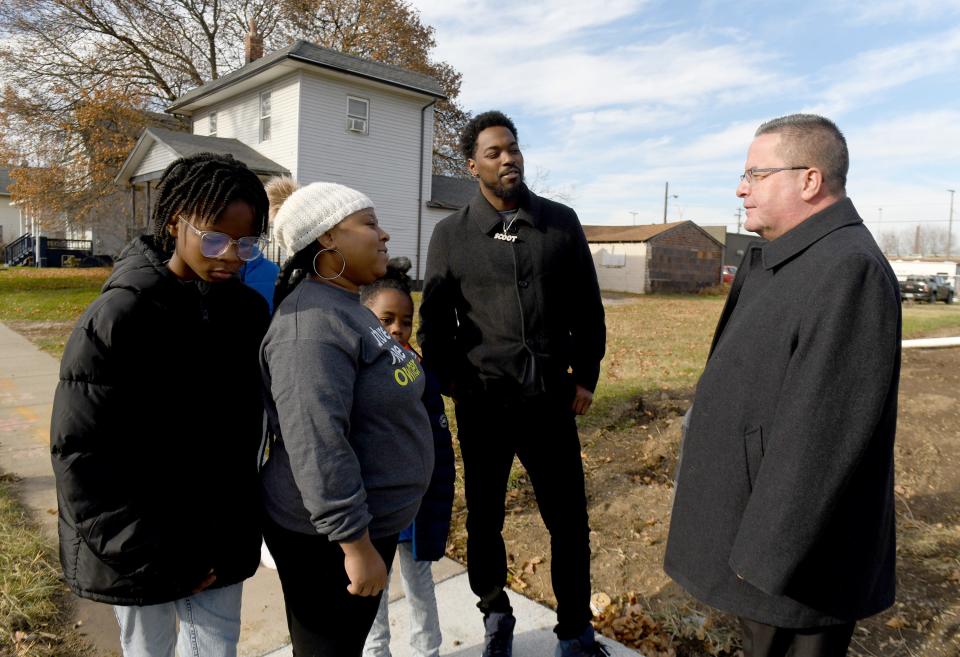 Catholic Diocese of Youngstown Bishop David Bonnar speaks with Ronnie Dykes and Ashya Mathis and their sons Josiah, 14, Jay'On, 12, and Jaiaire, 11 at their new Canton home. The house was built through Habitat for Humanity East Central Ohio with help from volunteers from Stark County Catholic churches.