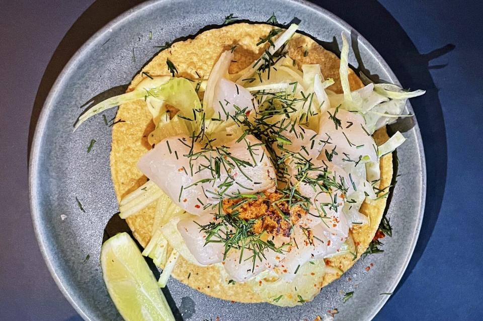 Scallops, onions and fennel atop a tostada