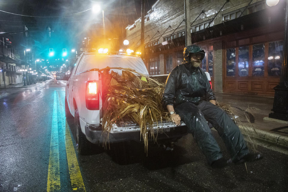 TAMPA, FL - SEPTEMBER 28   Lew Hendrix collects palm branches blown down by the outer bands of Hurricane Ian  in the Ybor City neighborhood of Tampa, FL, early Wednesday morning, September 28, 2022.  (Ted Richardson/For The Washington Post via Getty Images)