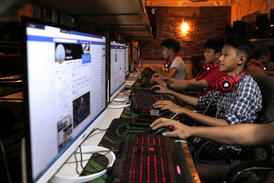 This picture taken on December 18, 2018 shows Myanmar youths browsing their Facebook page at an internet shop in Yangon. - Facebook has removed hundreds of additional pages and accounts in Myanmar with hidden links to the military, the platform said on December 19, as the company scrambles to respond to criticism over failures to control hate speech and misinformation. (Photo by Sai Aung MAIN / AFP)        (Photo credit should read SAI AUNG MAIN/AFP/Getty Images)