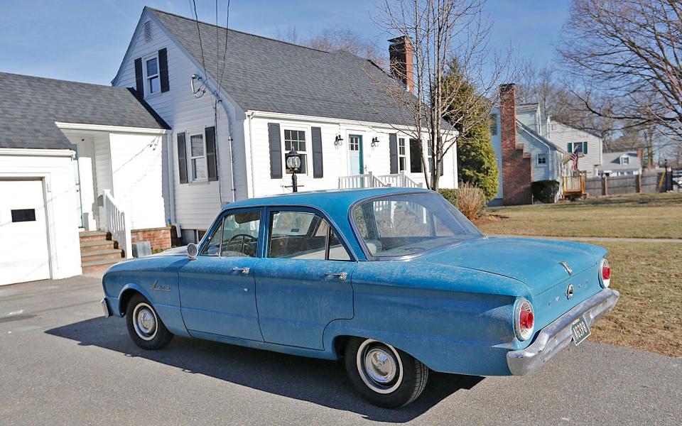A 1960s-era vehicle is parked near the closed Foster School in Braintree for filming of "Boston Strangler" on Thursday, Jan. 27, 2022.